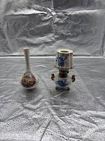 Front view of porcelain bud vase and miniature lamp