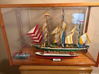 Display case housing Cutty Sark, RMS Titanic, toy tank