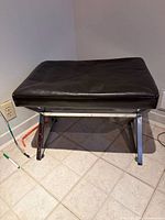 Front angled view of bench showing seat and chrome legs