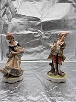 Both porcelain figurines showing overall form and size