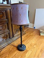 Full view of lamp with purple shade and metal base