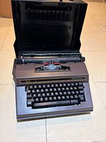 Front view of Sears Celebrity Electric 12 typewriter inside open case