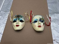 Both ceramic Venetian masks side by side