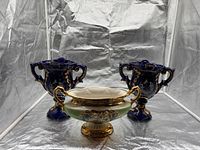 Full set showing two cobalt blue urn vases and central compote bowl