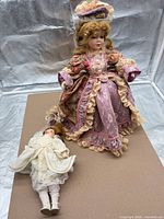 Large and small porcelain head dolls on display