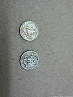 Obverse and reverse of both quarters showing overall wear