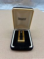 Money clip inside open Swank box, full view
