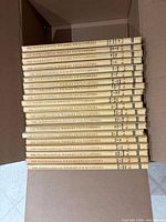 Stack of 20 hardcover encyclopedia volumes in open box