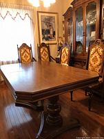 Table assembled with four chairs visible in dining room