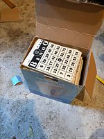 Box opened showing stack of vintage black and white bingo cards.
