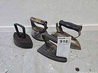 Group view of all four cast iron irons showing overall condition