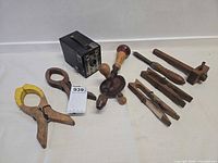 Group shot of all items including camera, drill, clamps, clothespins, marking clamp pieces and utensil