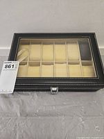Closed watch box showing glass top and exterior