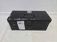 Closed black metal first aid box showing handle and latch