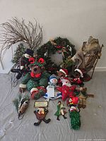 Group shot of wreath, plush figures, Santa, twig spray, ornaments