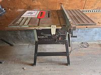 Full view of Delta table saw with stand, rip fence, throat plate