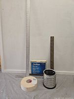 Overall lot with aluminum square, steel L-square, FibaTape box, paper joint tape, screws container