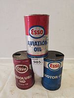 Front view of three Esso oil cans stacked