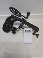 Overall view of cast iron apple peeler with clamp and hand crank