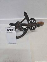 Full view of cast iron apple peeler with wood handle on side