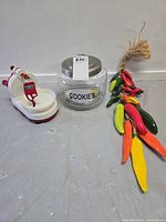 Overview of glass cookie jar, apple peeler, pepper ornament