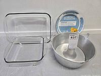 Group view of pie plate label, rectangular casserole with lid, square casserole, aluminum tube cake pan
