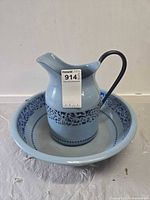 Pitcher inside basin, front view with sticker