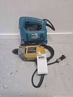 Makita 4323 jigsaw and Black & Decker drill with cords shown together