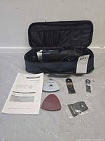 Open case with multi-tool, manual and accessories displayed