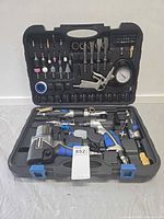 Kit open showing all major air tools and accessories positioned in case lid and base