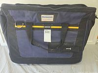 Front view showing Mastercraft logo, pockets, handles, damaged zipper
