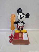 Front view Mickey Mouse telephone with handset and keypad visible