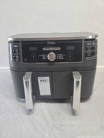 Front view of Ninja dual-zone air fryer showing two drawers and control panel