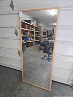 Front view of full-length mirror showing wood frame and reflective surface