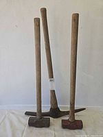 Full view of three tools standing upright