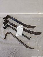 Four pry bars grouped together, various shapes and sizes