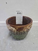 Front view showing brown and green glaze and overall form