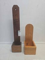 Front view of both wooden wall holders showing finishes and box bases