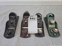 Front view of four Stanley block planes showing finishes and hardware