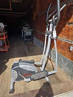 Full view of Sunny Health & Fitness SF-E905 elliptical showing frame, pedals, handles