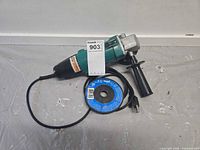 Angle grinder with cord, side handle, and disc