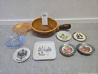 Group shot of all items: five plates, two glass bowls, ceramic pan, tag visible