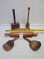 Group view of all wooden utensils with tape measure for scale