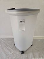 Full view of white container on casters with auction label visible