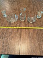 Group shot of all five clear glass pieces with measuring tape