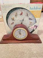 Both clocks; Audubon wall clock boxed behind wooden mantel clock