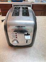 Front view showing Black & Decker logo, control buttons, browning dial, stainless face