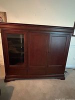 Front view of cherry entertainment center cabinet