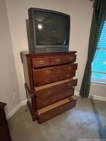 Full view of Broyhill tallboy chest with several drawers open