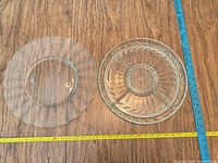 Both plates side by side with measuring tapes showing diameters
